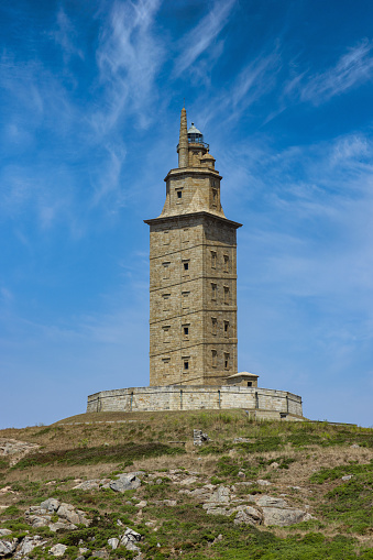 A Coruña famous ancient roman Hercules Tower - Torre de Hércules (Tower of Hercules) Coastal Lighthouse under blue summer skyscape. Torre de Hércules, A Coruna, Galicia, Northern Spain, Spain, Europe.