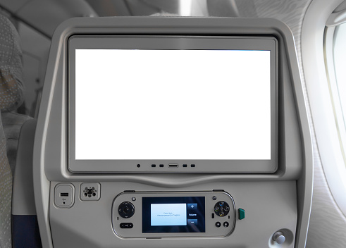Blank empty screen TV white display on seat in cabin airline plane or airplane in transportation and travel in holiday vacation concept. Journey on board.