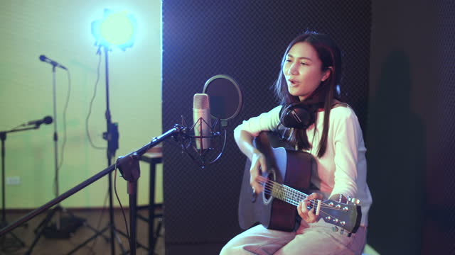 Asian Acoustic Female Singer In Reccording Studio