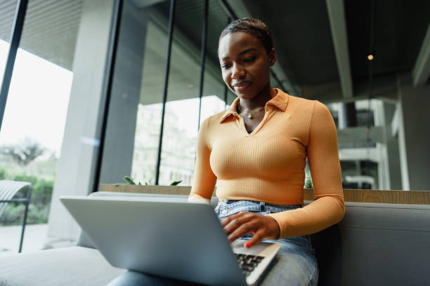istock African female student working on computer in public place 1470427493
