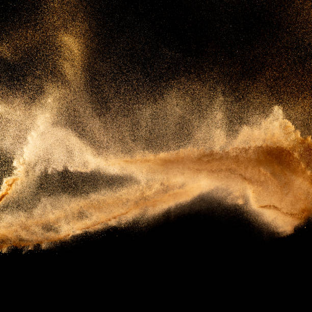 istock Brown colored sand splash.Dry river sand explosion isolated on black background. 1470428849