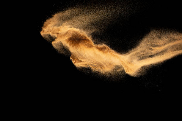 istock Brown colored sand splash.Dry river sand explosion isolated on black background. 1470428874