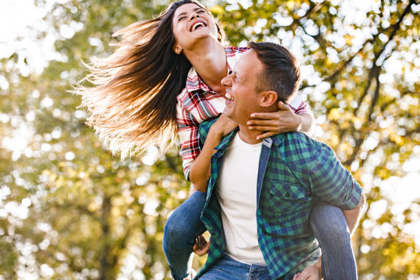 istock Happy couple having fun while piggybacking in springtime. 1470430024