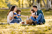 Cheerful family communicating in spring day at the park.