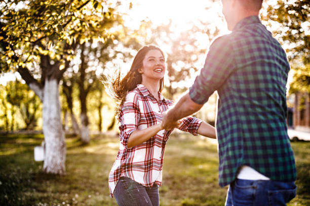 istock Carefree couple having fun while spinning at the park in springtime. 1470430398