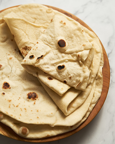 Soft lavash bread on white background. Homemade freshy baked lavash bread is perfect for kebabs, shawarma and other dishes. Only water, yeast, flour and salt. High quality photo