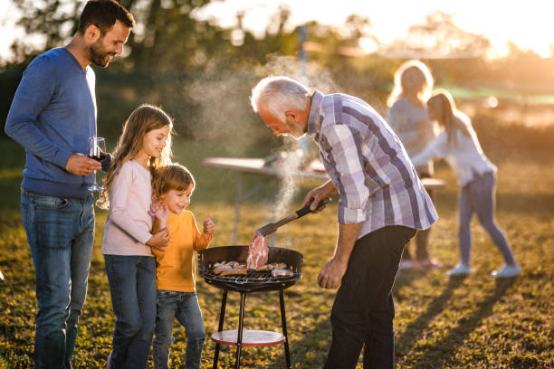 istock Extended family having barbecue time in the front yard. 1470431350