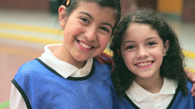 Candid headshots of two elementary age friends