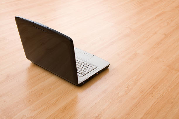 istock Laptop on a hardwood floor 147043230