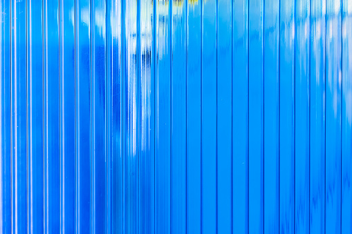 Light transmission effect of blue wavy striped glass wall
