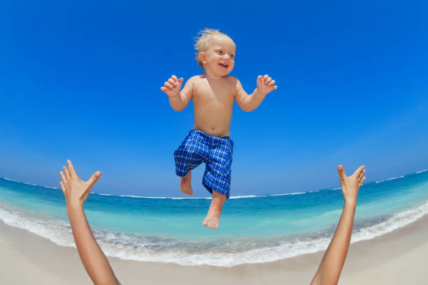 istock Father throwing up in the air a happy child 1470434814