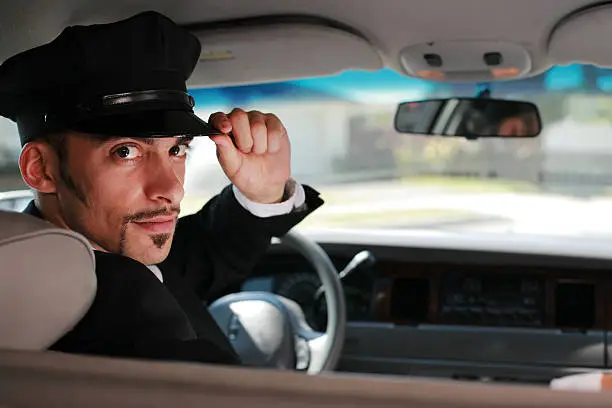 Portrait of handsome male chauffeur saluting a viewer