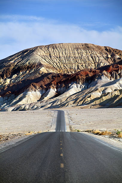 istock desert mountain road - death valley CA 147043722