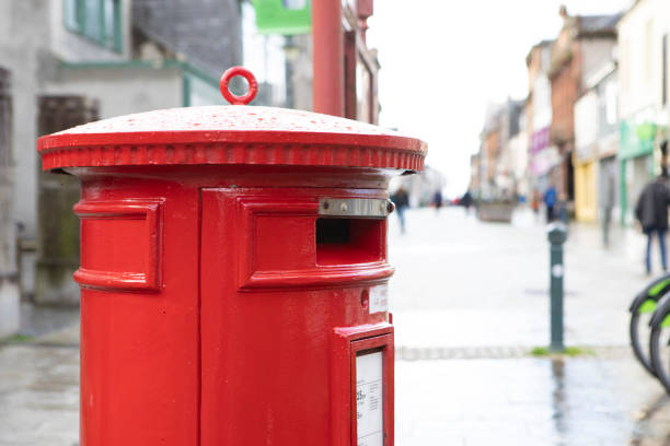 istock Red postbox in a high street on a wet day 1470439946