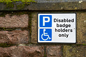 Disabled parking sign on a church wall