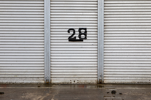 Handwritten number 28 on a closed business unit