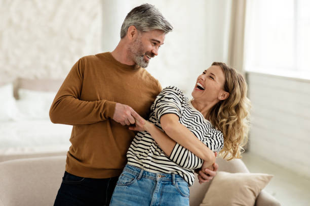 istock Joyful Couple Dancing And Laughing Having Fun At Home 1470440658