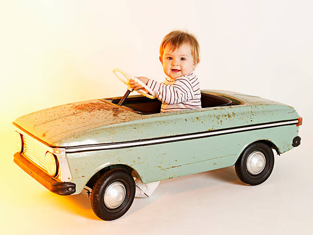 istock cute girl driving toy car 147044107