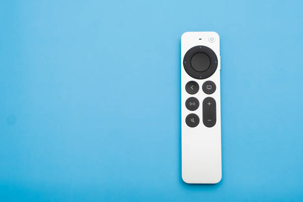 Siri Apple Tv 4k Remote controller on the blue background with copy space
