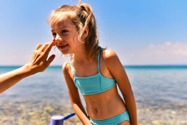 istock Mother applying suntan lotion on daughter 1470442353