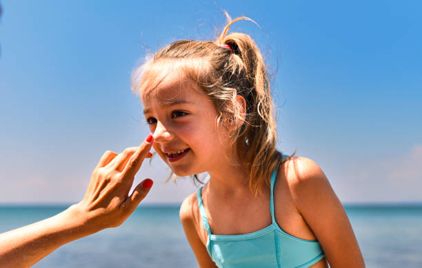 istock Mother applying suntan lotion on daughter 1470442386