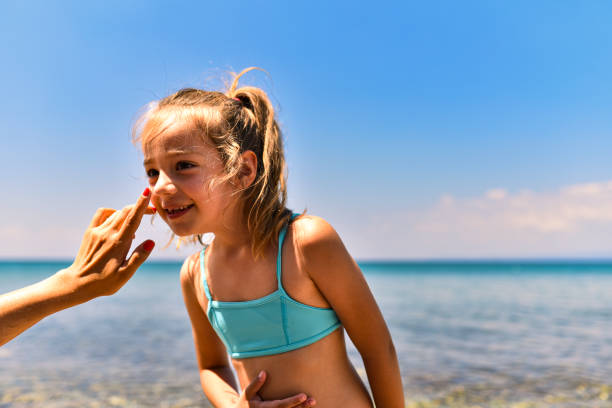 istock Mother applying suntan lotion on daughter 1470442462