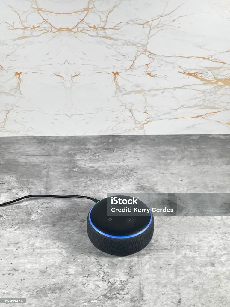 Amazon Alexa smart speaker on a clean modern  kitchen surface. Virtual Assistant Stock Photo