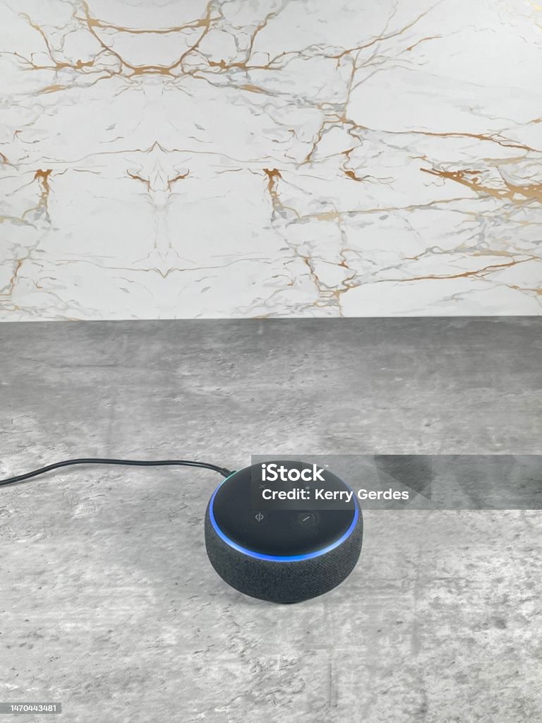 Amazon Alexa smart speaker on a clean modern  kitchen surface. Bluetooth Stock Photo