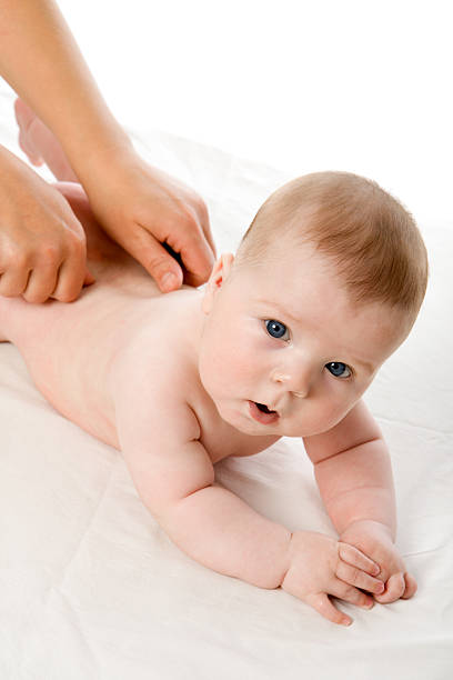 istock The feminine hands massage cute baby boy 147044352