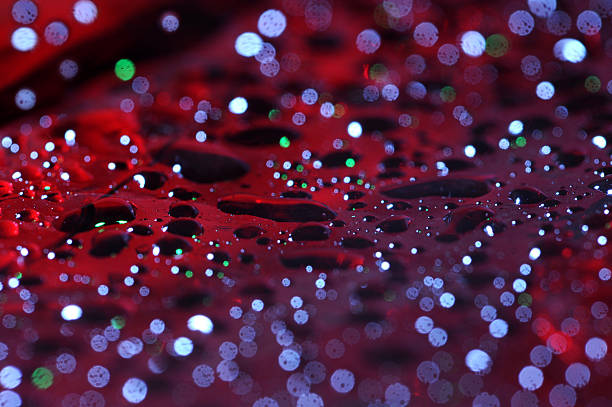 water drops on red surface stock photo