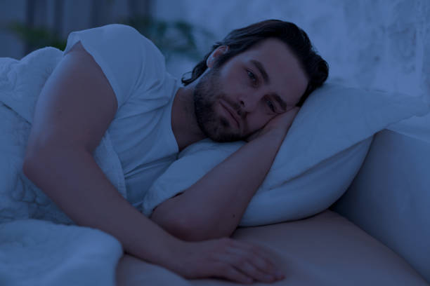 istock Depressed man cant sleep at night, laying in bed alone 1470444662