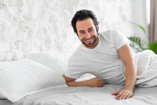 istock Handsome young man laying in bed, waiting for his lady 1470444679
