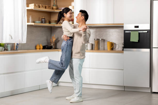 istock Romantic chinese lovers dancing waltz at kitchen 1470445032