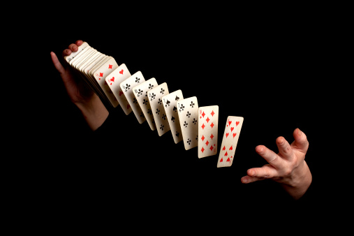 magician showing his trick on black background