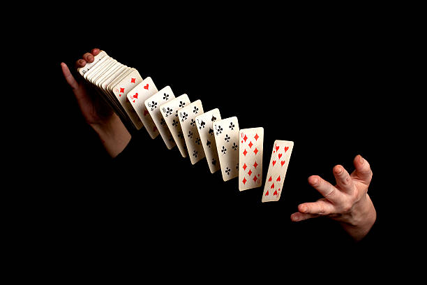 Magician with cards on black background magician showing his trick on black background magic trick photos stock pictures, royalty-free photos & images