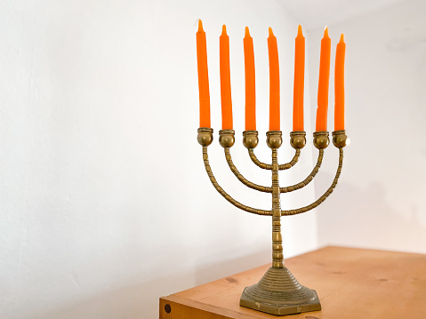 Still life with jewish candlestick and orange candles at home