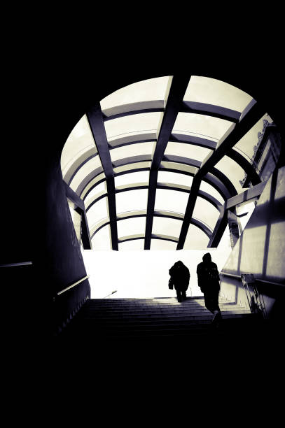 istock Silhouettes of people going up the staircase. 1470446736