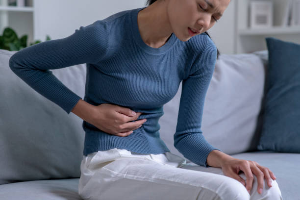 istock Young Asian woman suffering from strong abdominal pain. 1470446882