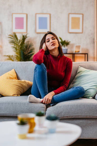 istock Young Woman Sitting On The Sofa At Home At Night 1470447063