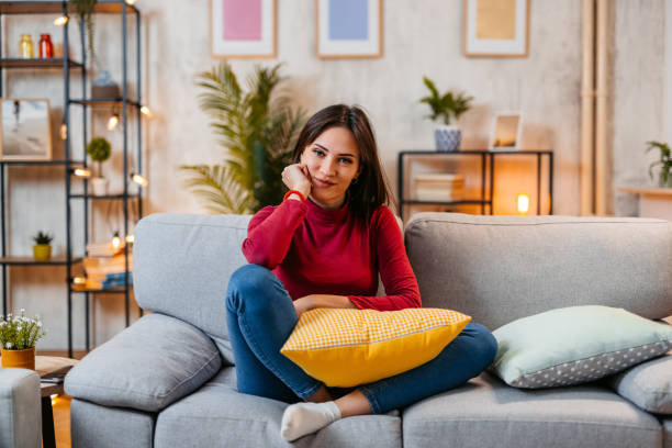 istock Young Woman Sitting On The Sofa At Home At Night 1470447170