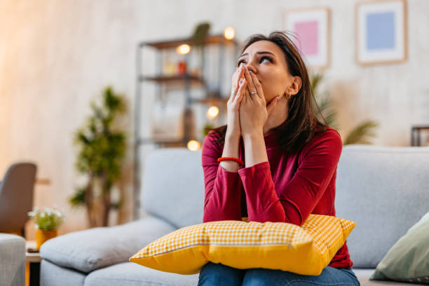 istock Sad Young Woman Sitting At Home On The Sofa At Night 1470448630