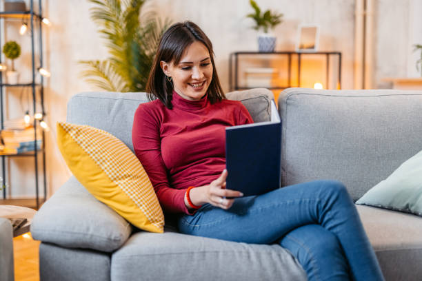 istock Young Woman Reading A Book At Home At Night 1470448669