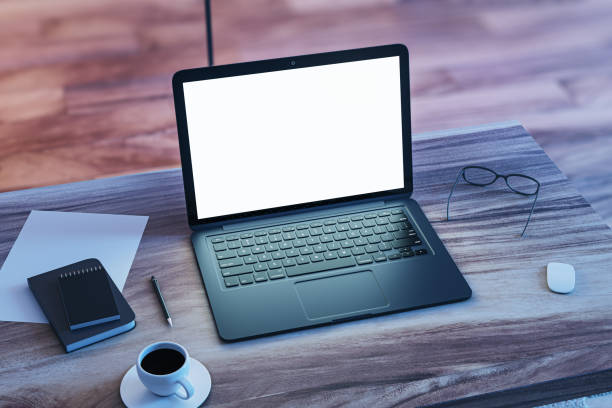 istock Perspective view on blank white modern laptop screen with space for your web design or landing page on wooden table with coffee cup and office tools on floor background. 3D rendering, mock up 1470448713