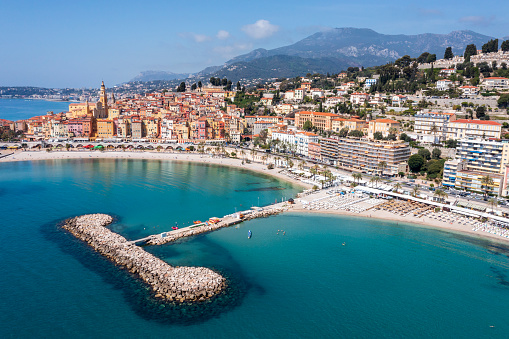 Aerial view of a blue sea, beach and hotels in vacation town Menton, Cote d'Azur, French Riviera, Mediterranean Sea.