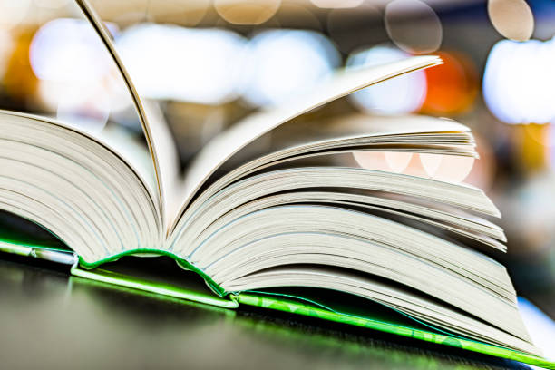 istock An open hardcover book on a table in a public library 1470450081
