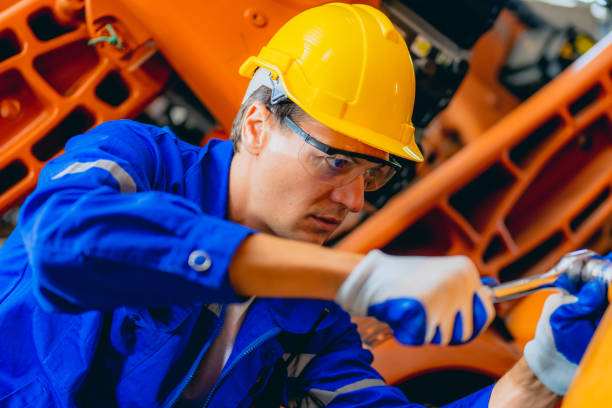 istock Professional maintenance worker with machine robotic arms at industrial factory 1470450129