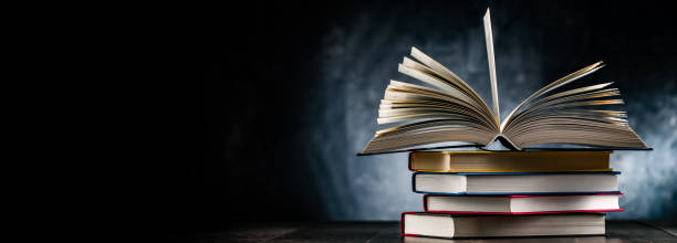 istock A composition with an open book lying on a stack of other books 1470450502