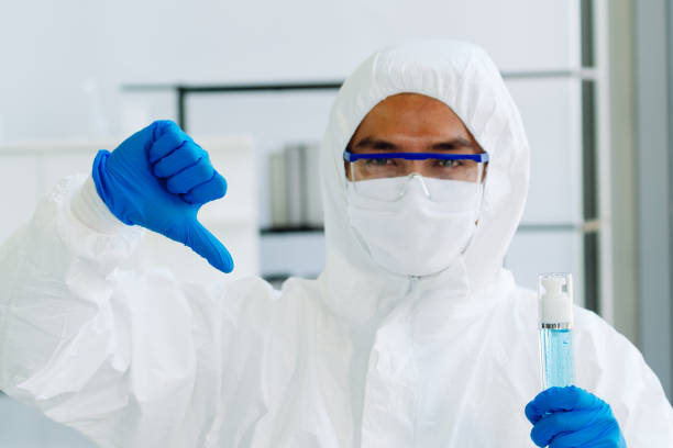 istock Lab Technician in Personal protective equipment  PPE suit No Good hand gesture 1470454315