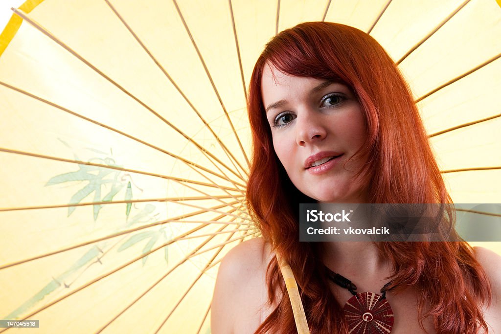 Beautiful red haired girl with parasol Beautiful red-headed girl with yellow parasol. Adult Stock Photo