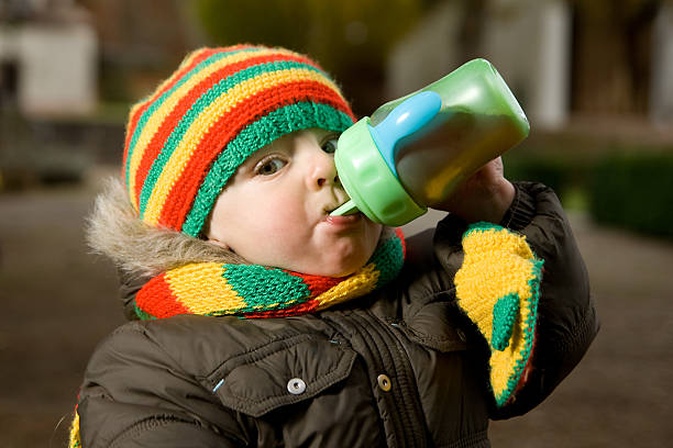 istock Cute baby is drinking from the bottle 147045669